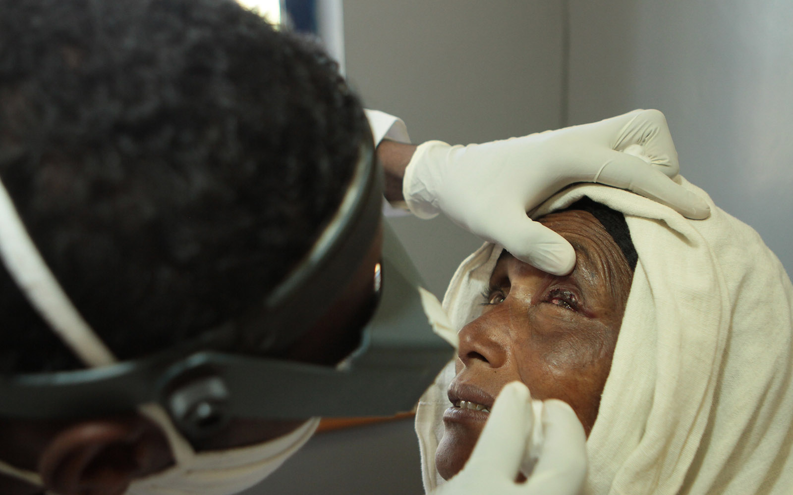 doctor checking the eyes of a woman