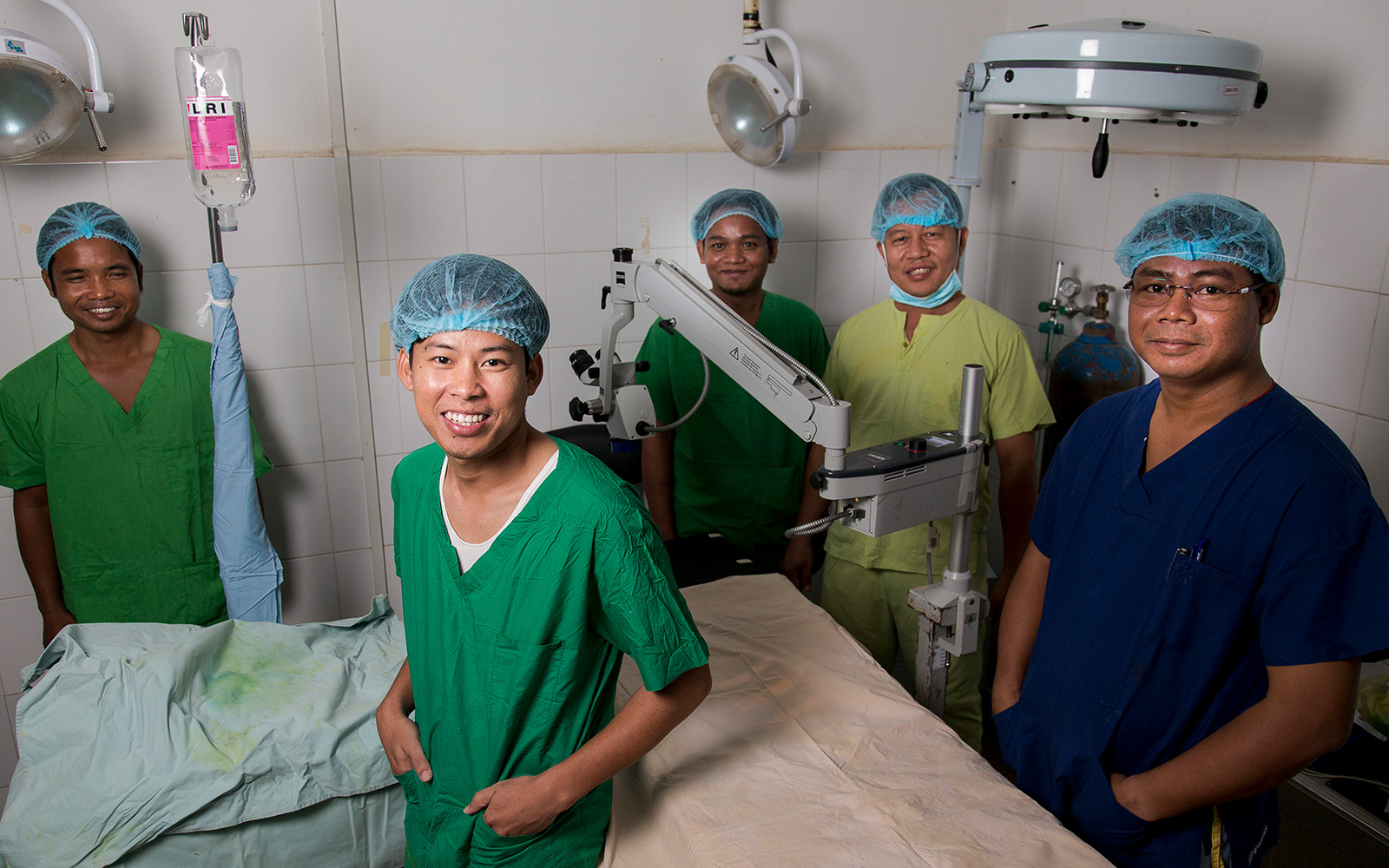 team of nurses and doctors wearing scrub suit in the operating room
