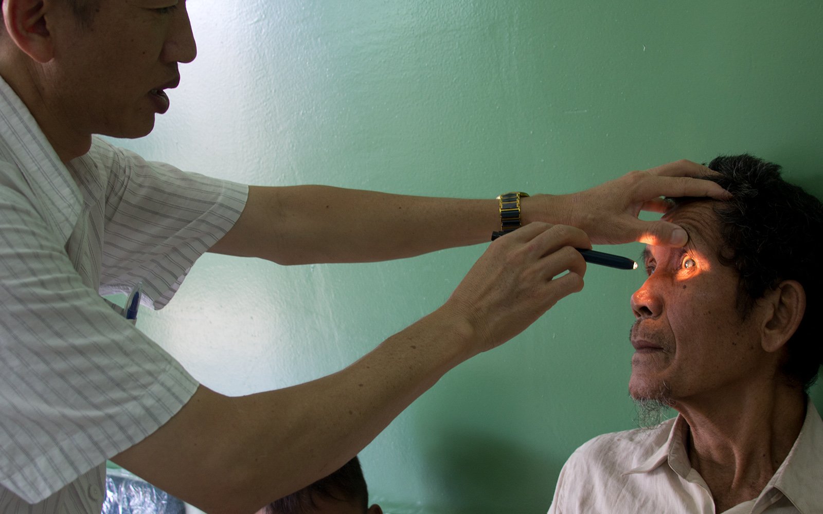 Cambodia male patient receives eye exam