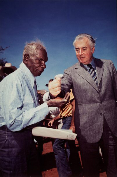 Prime Minister Gough Whitlam pours soil into the hands of traditional land owner and Aboriginal rights activist, Vincent Lingiari, Northern Territory, 1975