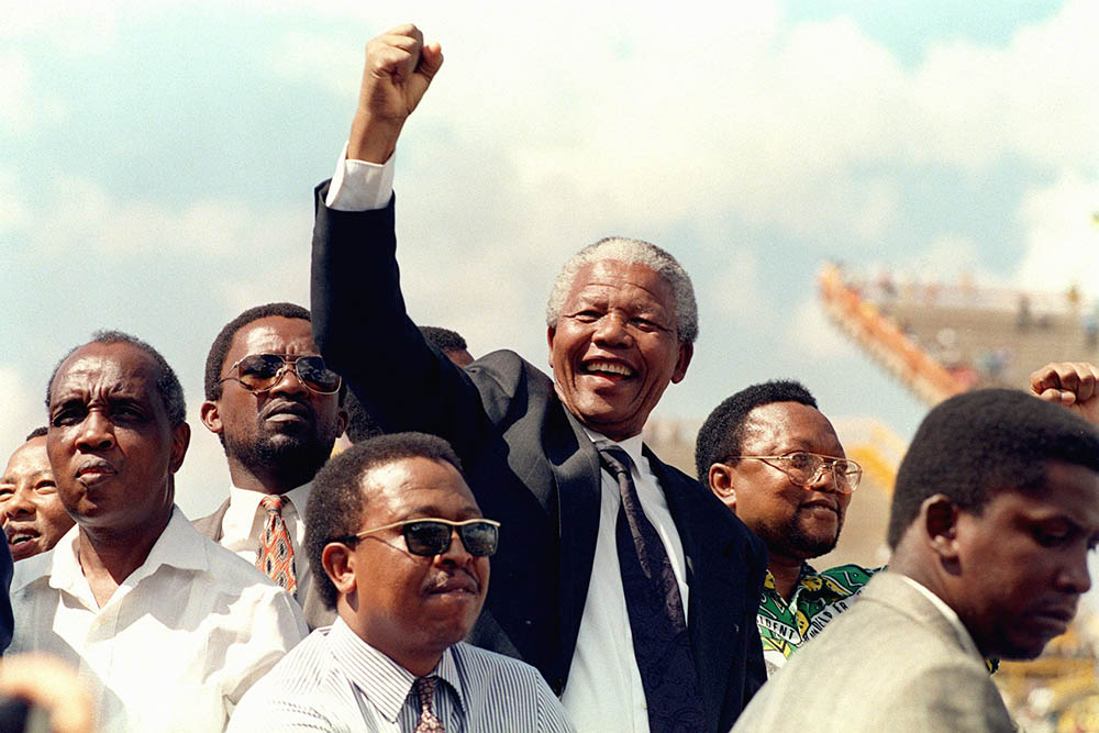 Nelson Mandela motivating his supporters with a fist pump at an election rally, Mmabatho, South Africa, 1994.
