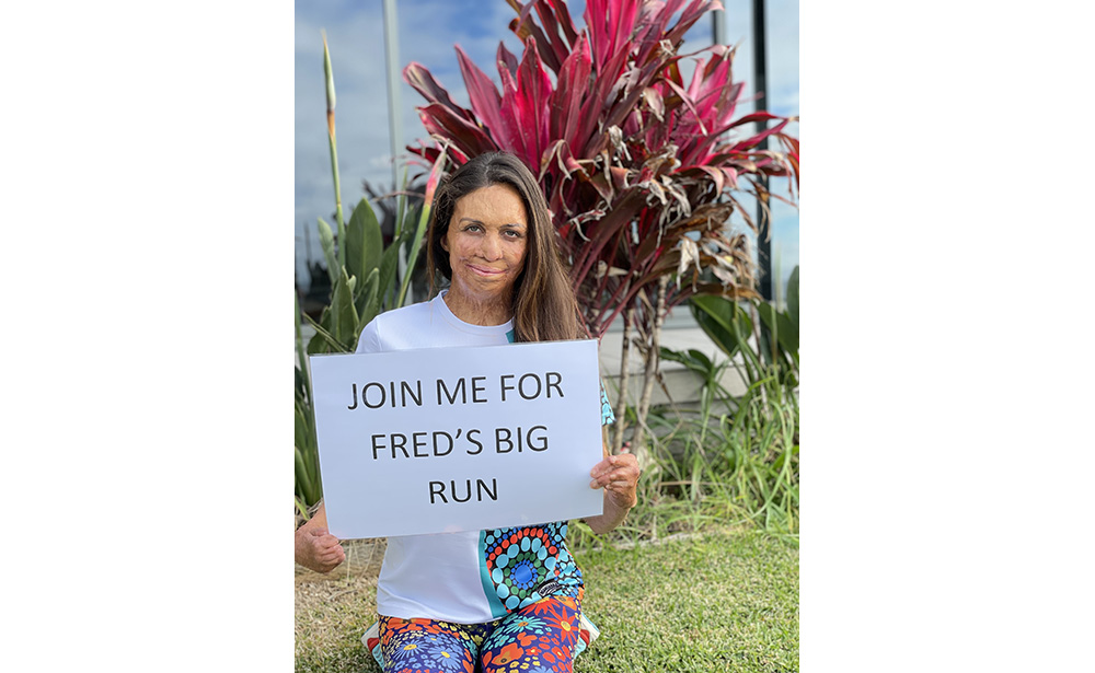 Turia Pitt holding a sign saying "Join me for Fred's Big Run".