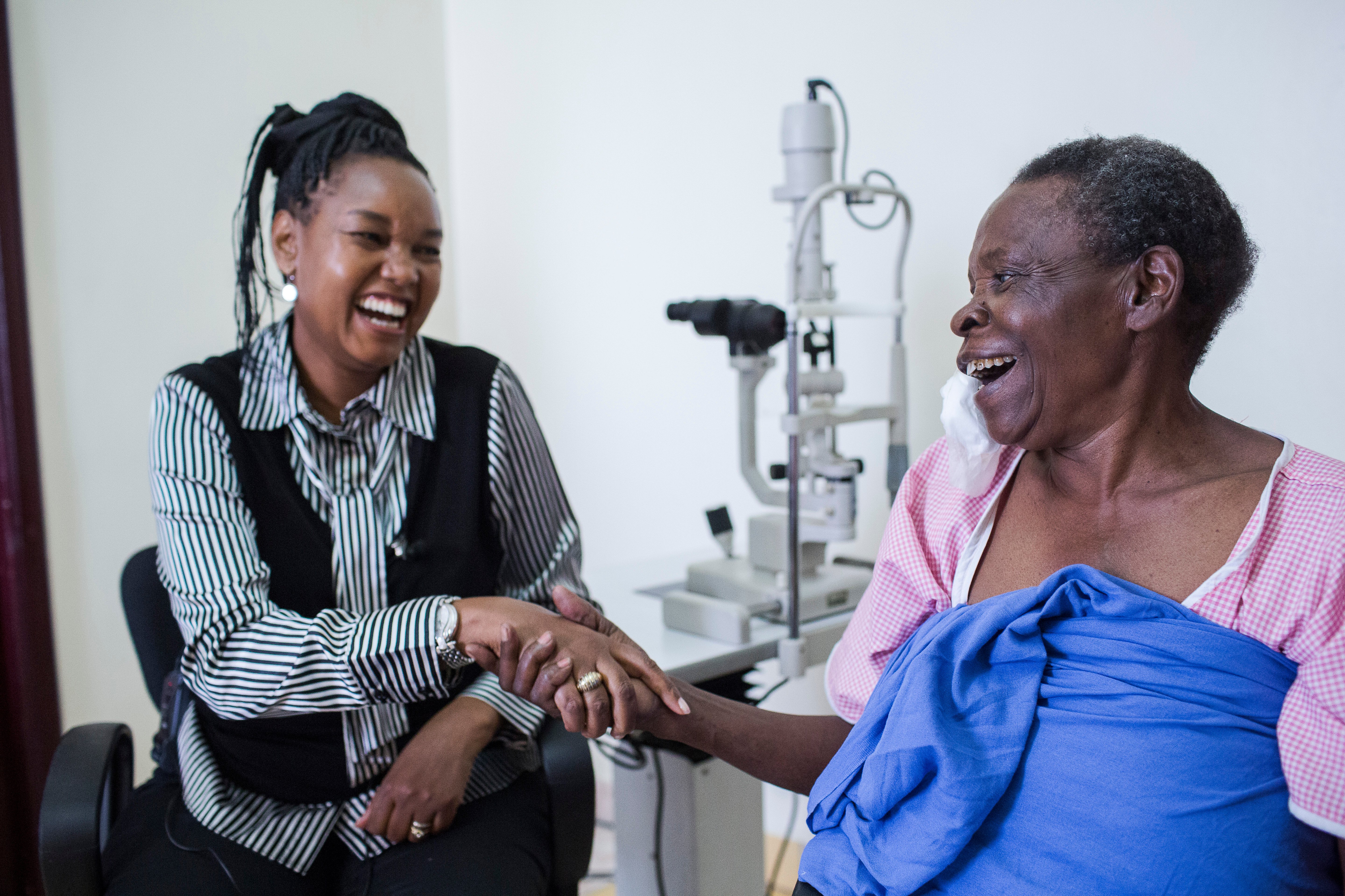 Francine celebrates with Dr Ciku Mathenge after successful cataract surgery restored her sight in Rwanda. Blind for more than three years, the 76-year-old was overjoyed to see her home, community and daily life once again.