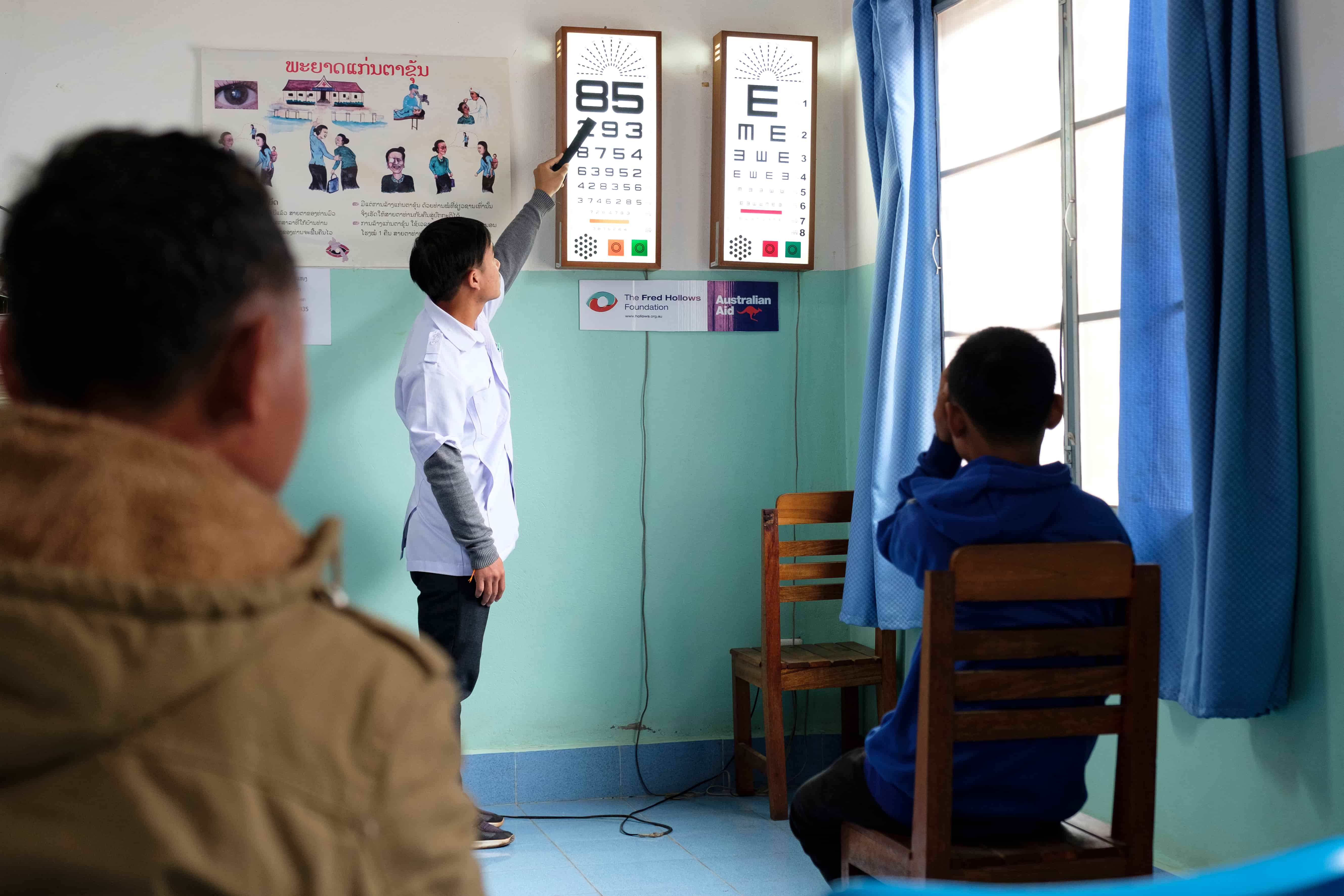 Bounthong, 13, from Oudomxay Province in Lao PDR, reads letters during an eye examination after struggling with cataract that affects his vision at school and at home.