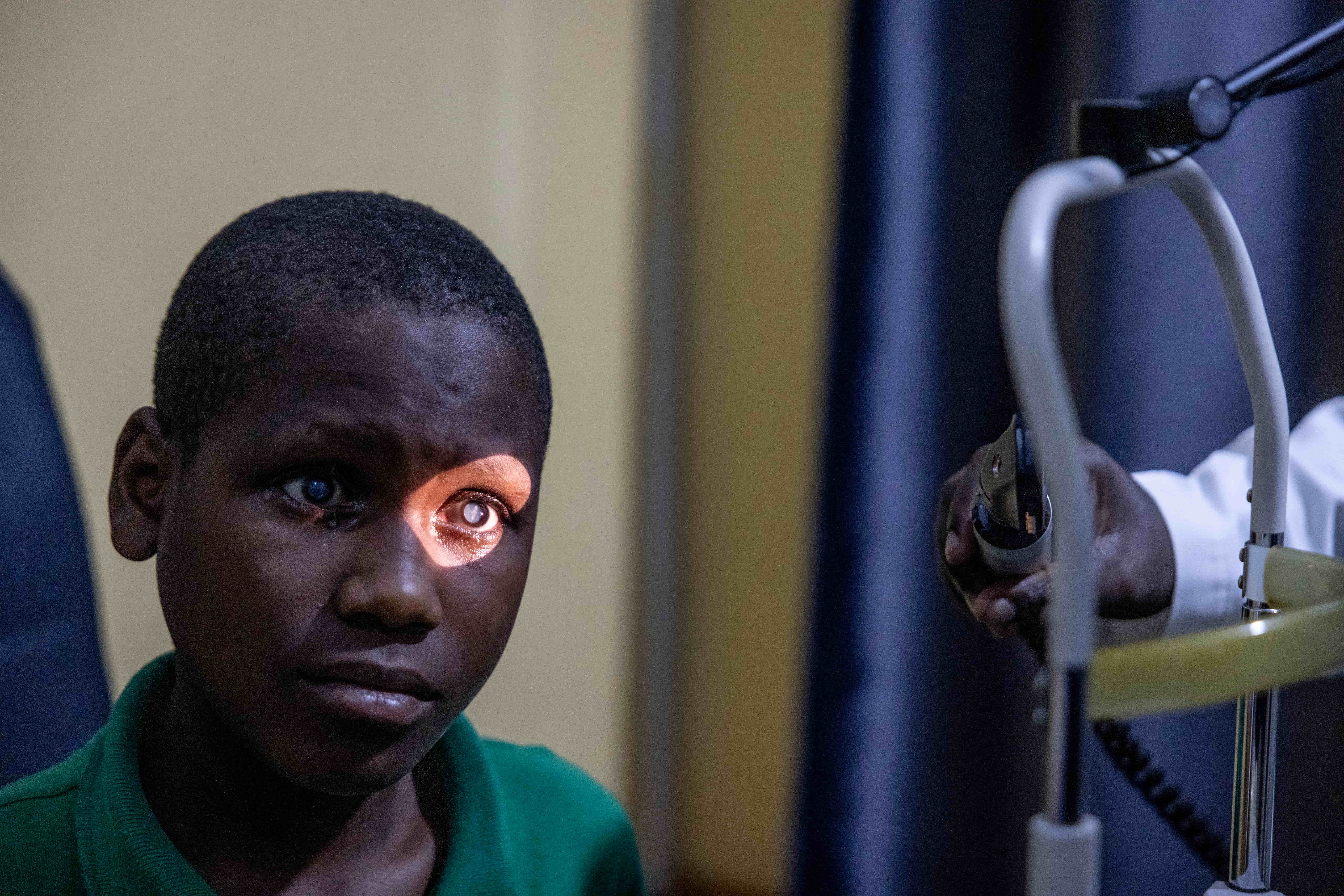 Fidel, 12, from Rwanda, receives an eye examination at Kabgayi Eye Unit supported by The Fred Hollows Foundation.