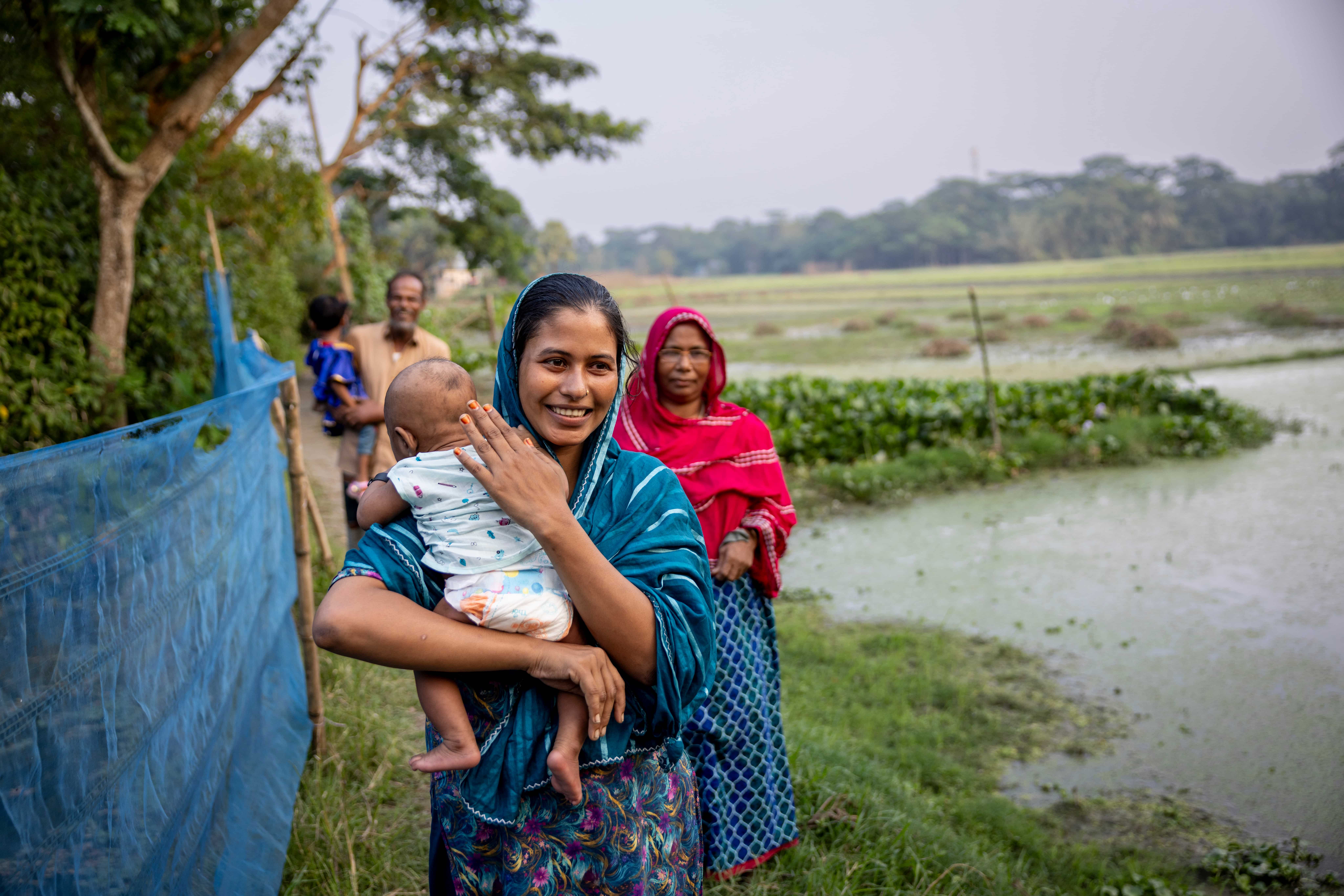 Parveen with her baby at home outside