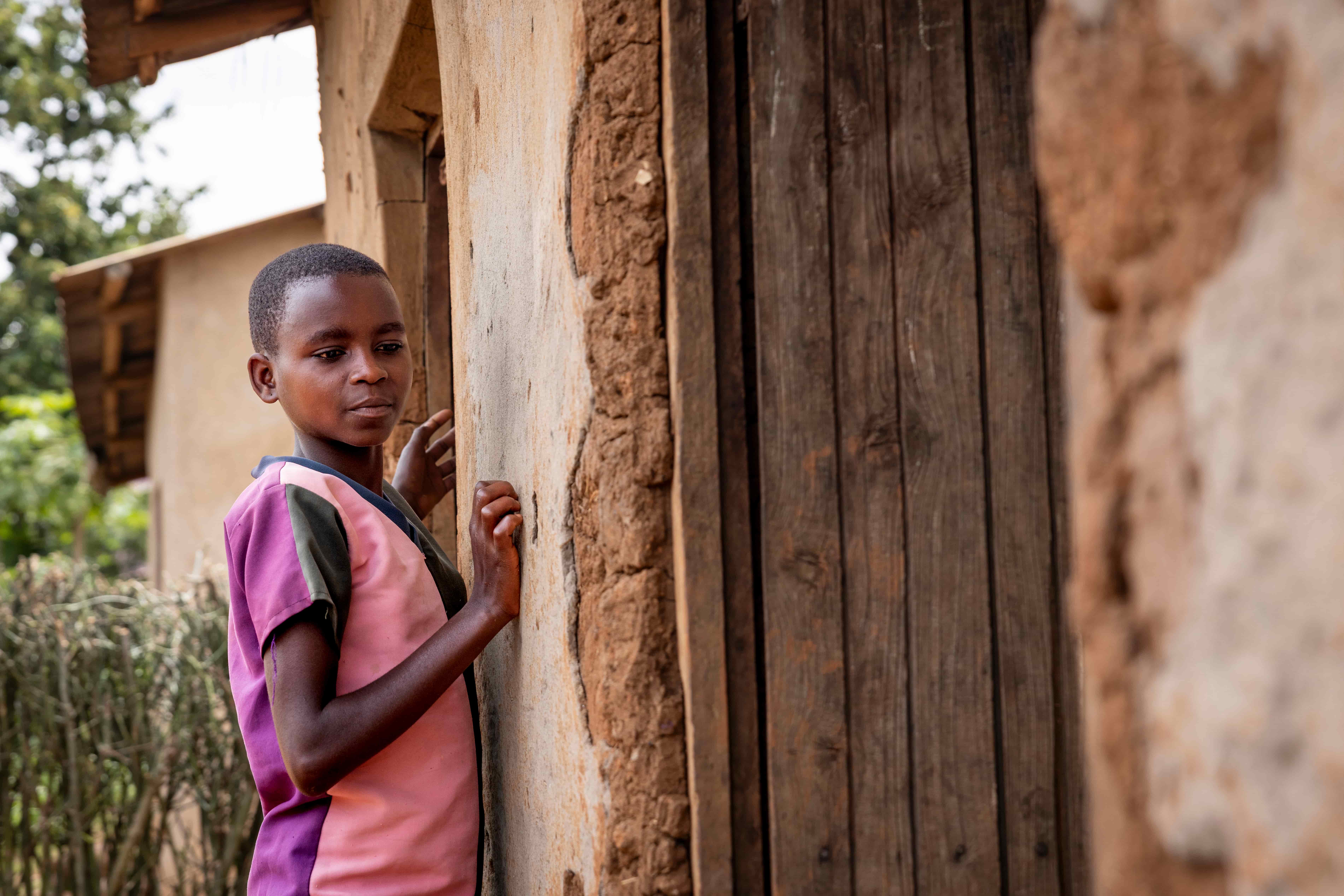 Valentine outside her home in Rwanda.