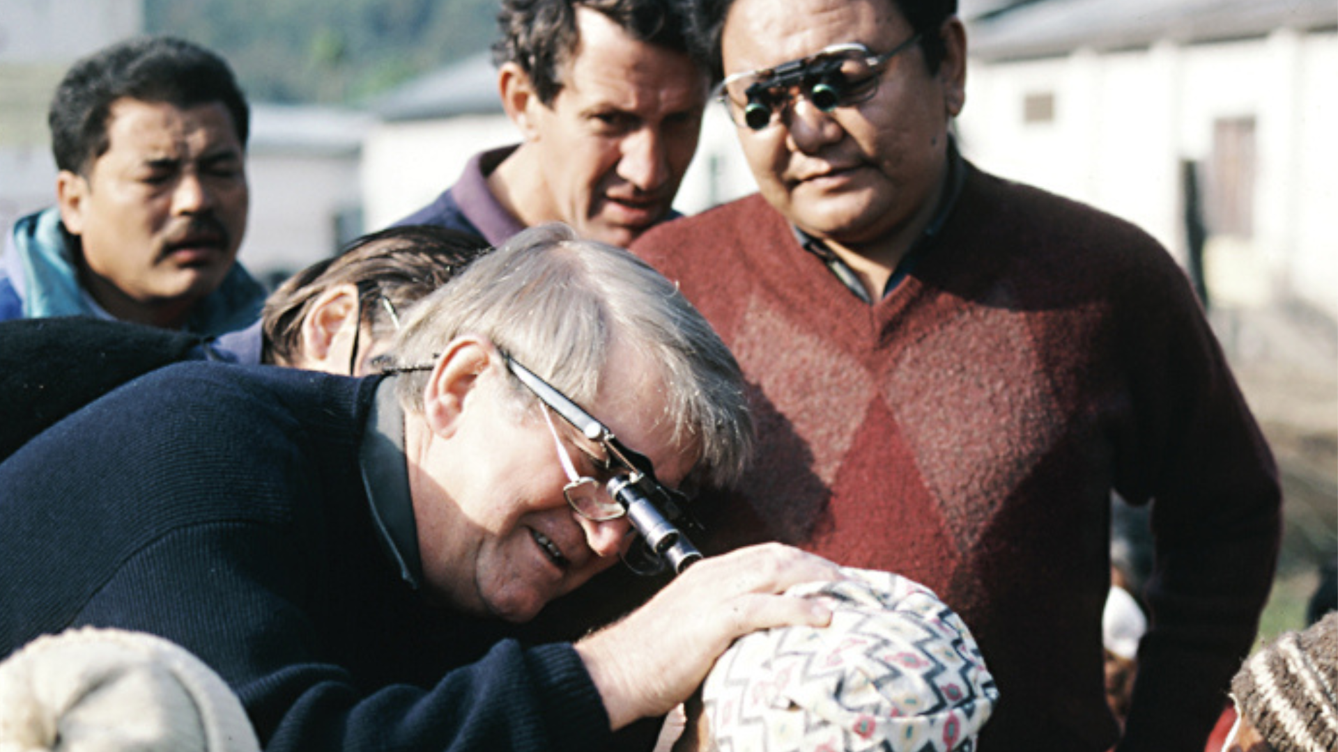 Fred Hollows and Dr Sanduk Ruit examining a patients eyes 