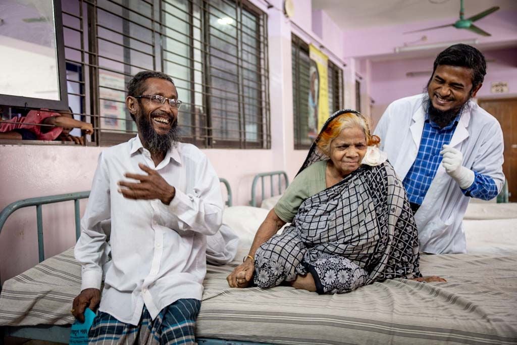 After living with blindness for a year, 75-year-old Hajera Khatun smiles as her eye patch is removed following cataract surgery. With her sight restored, she hopes to regain her independence and no longer rely on her family for everyday tasks.