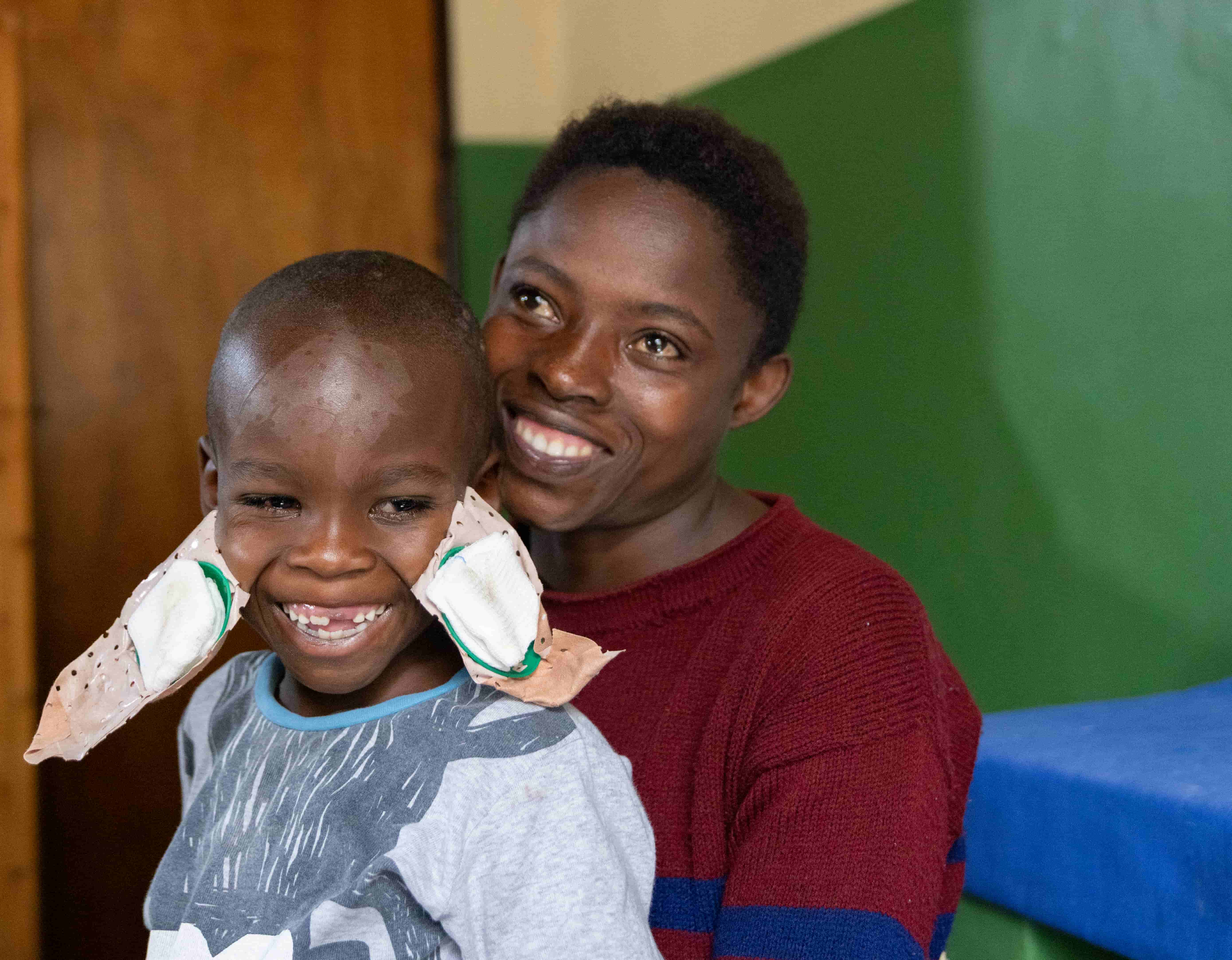 Blaise shares a joyful moment with his mum, Redempta, after his cataract surgery.