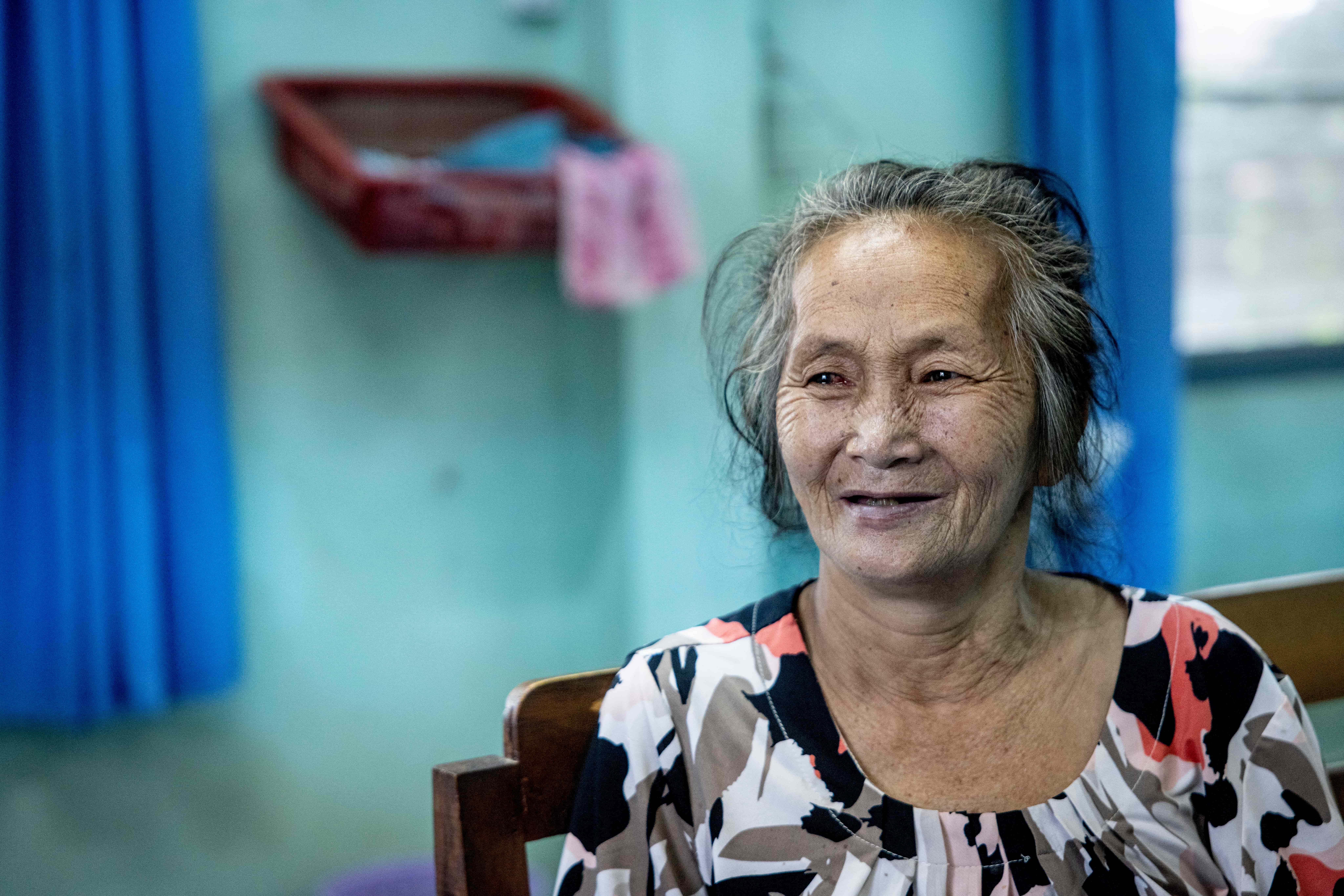 Yerng, 78, smiles after successful cataract surgery at Oudomxay Provincial Hospital in Laos. With her sight restored, she is looking forward to returning to farming and raising chickens.