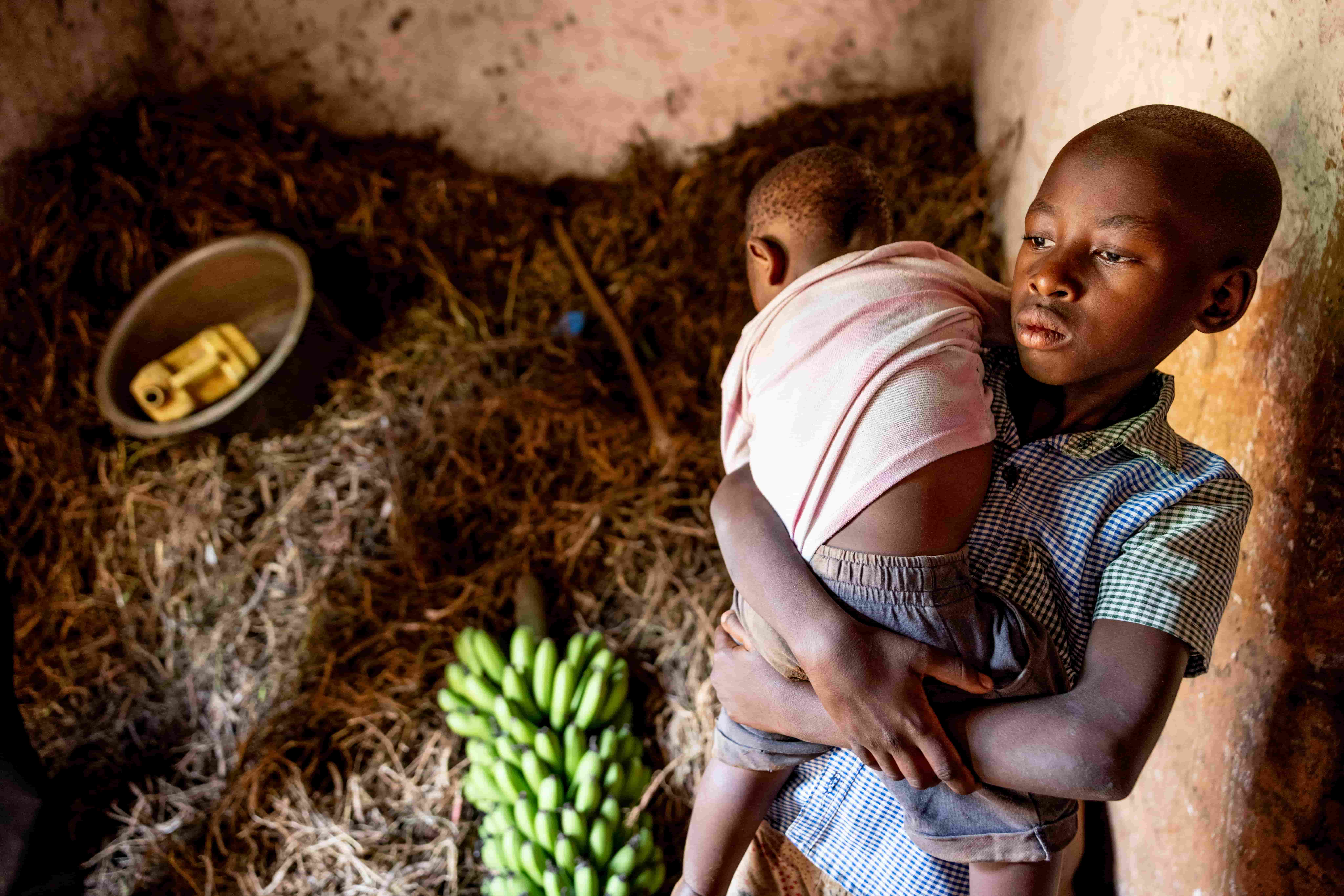 Patrick with his sibling at home in Rwanda