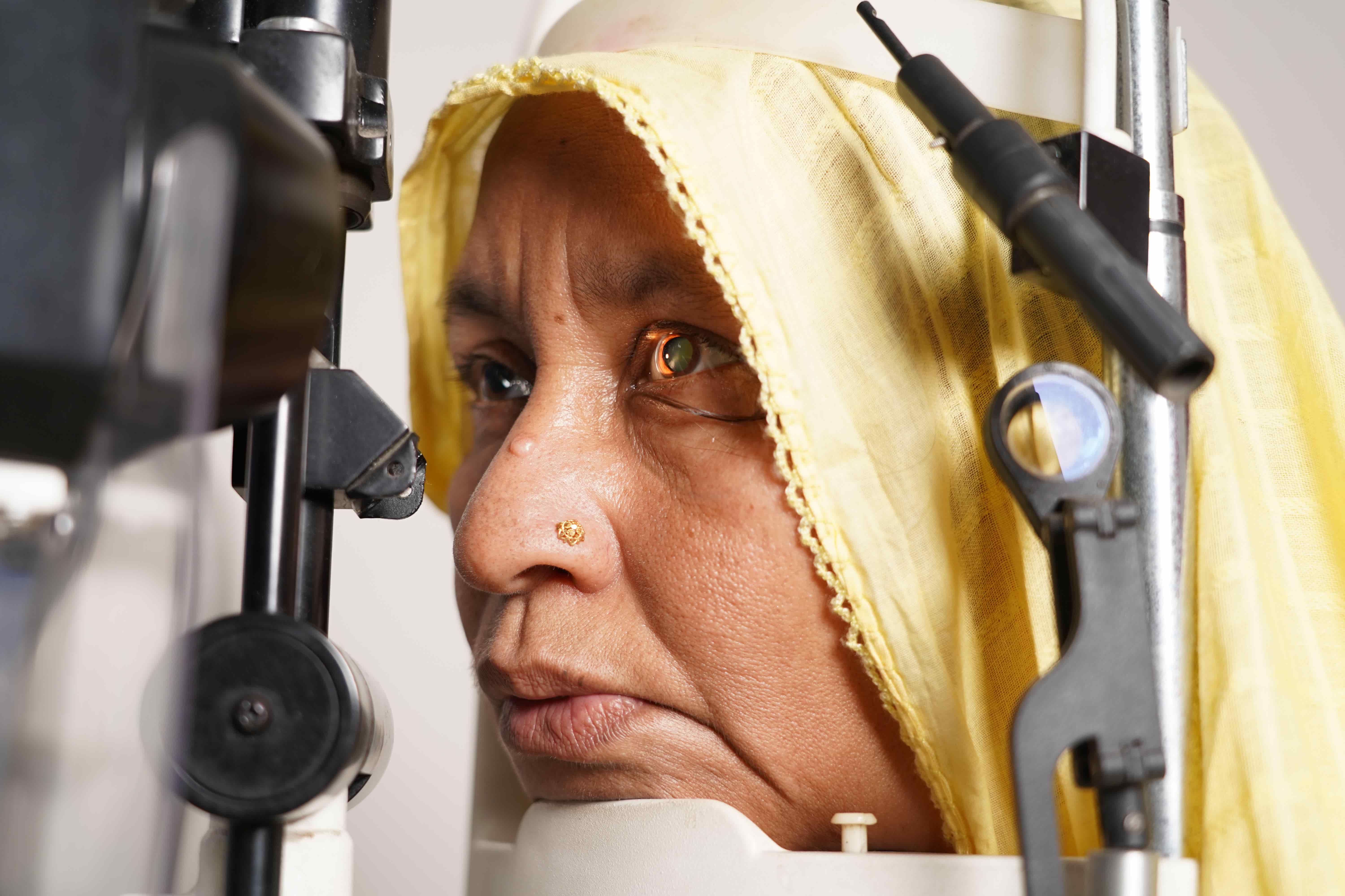 Nargis Begum from Bangladesh during an eye examination for diabetic retinopathy, receiving care to protect her sight so she can continue life with her family.