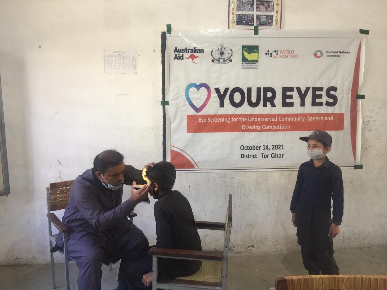 A health worker examines a child&rsquo;s eyes during a World Sight Day 2021 event in Pakistan
