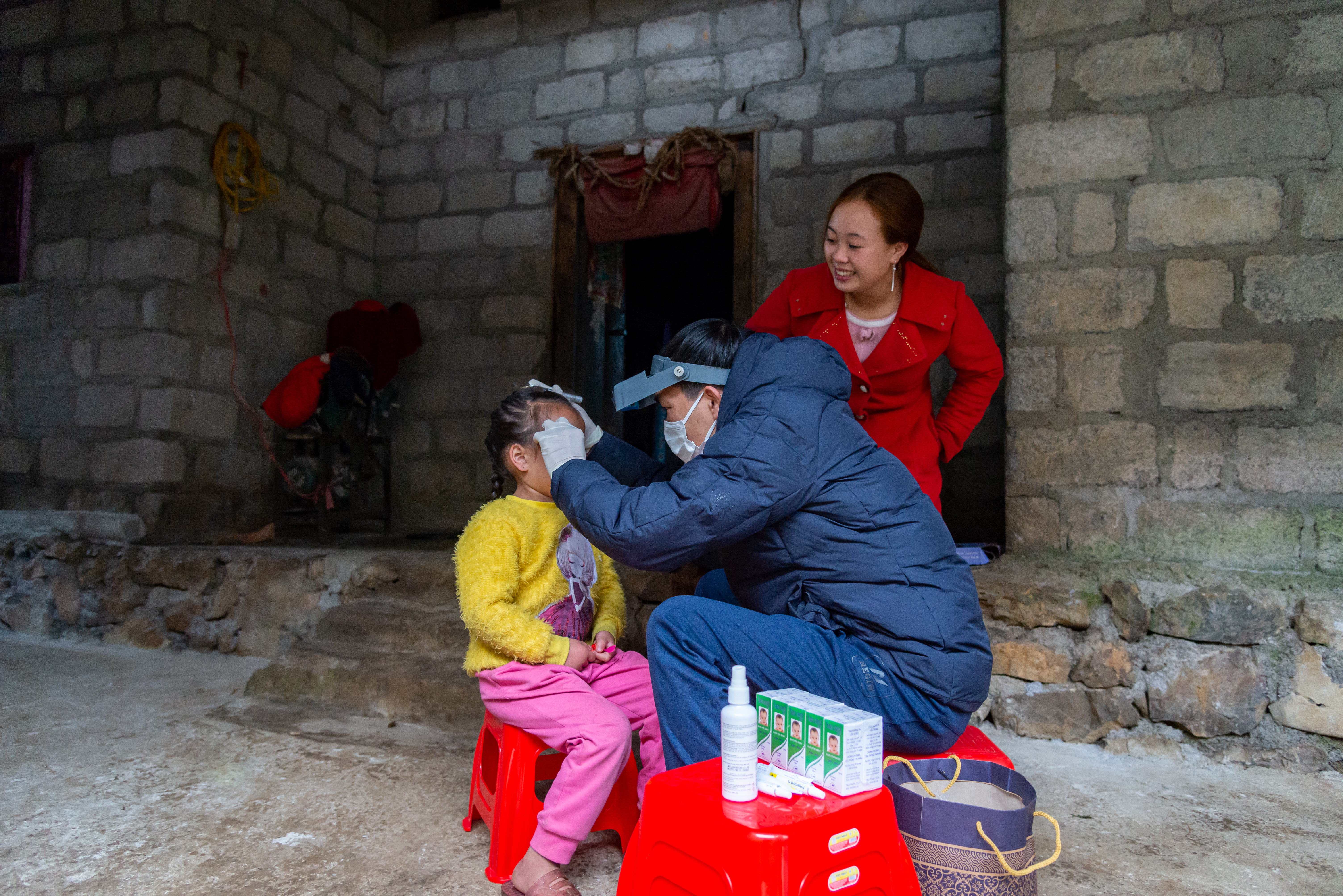 Health workers walk through a village in Ha Giang province, Vietnam, conducting the final trachoma surveillance survey to collect data for WHO validation of trachoma elimination.