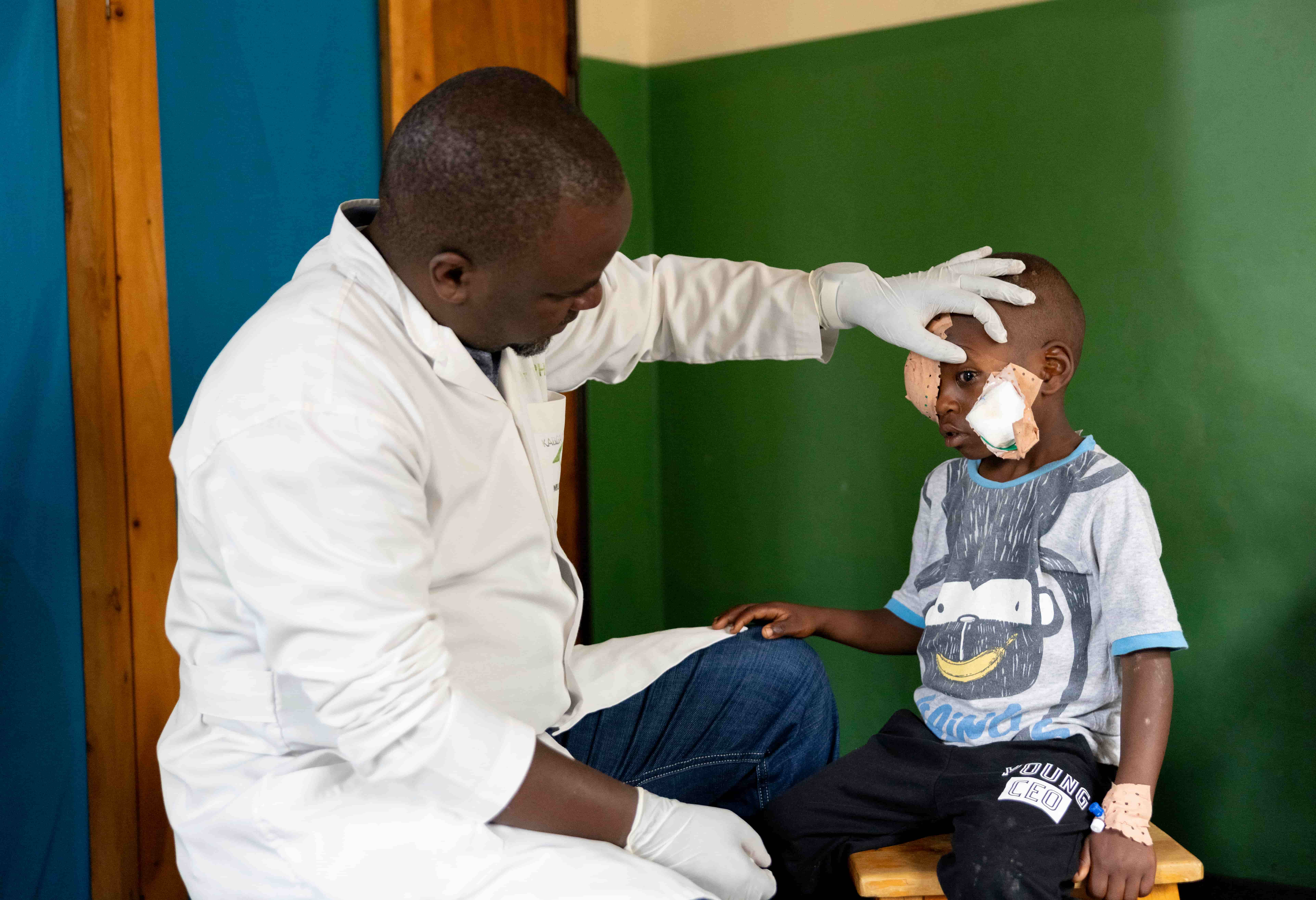 Dr Theophile examining Blaise's eye after cataract surgery.