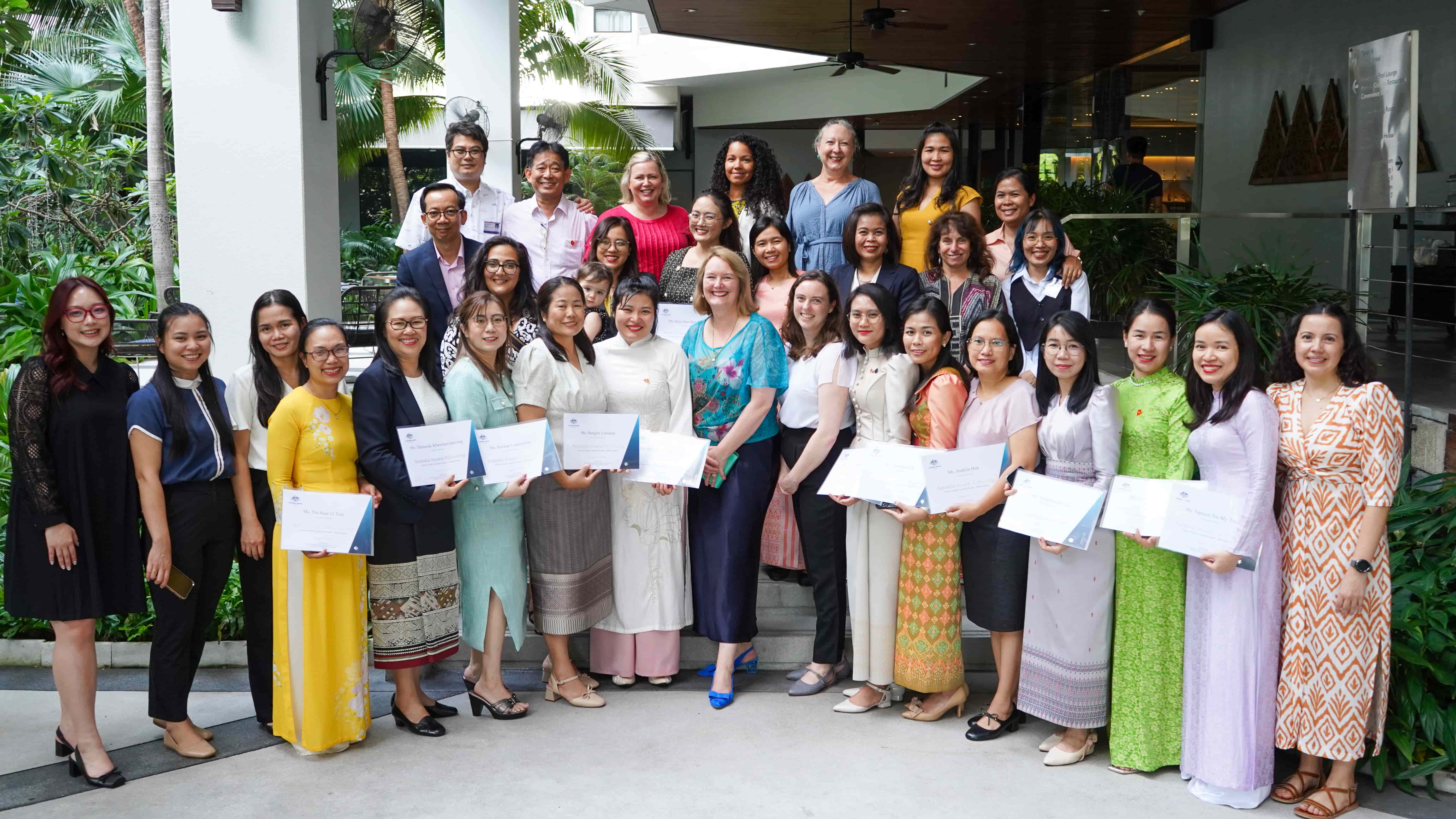 Participants of the Mekong Program holding up their certificates outside the venue. 