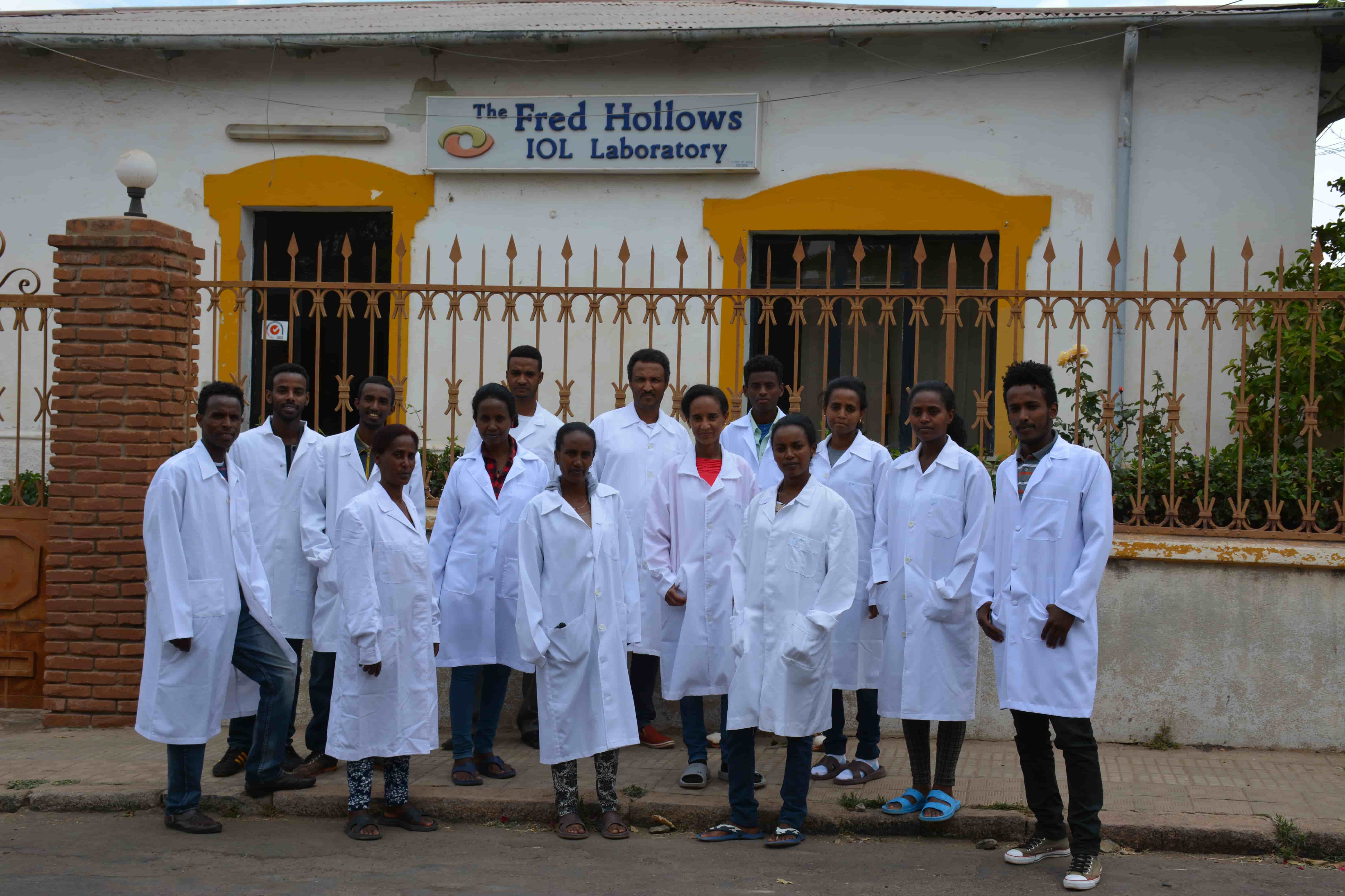 “Team members and local staff outside the IOL factory in Eritrea, producing lenses to restore sight.”