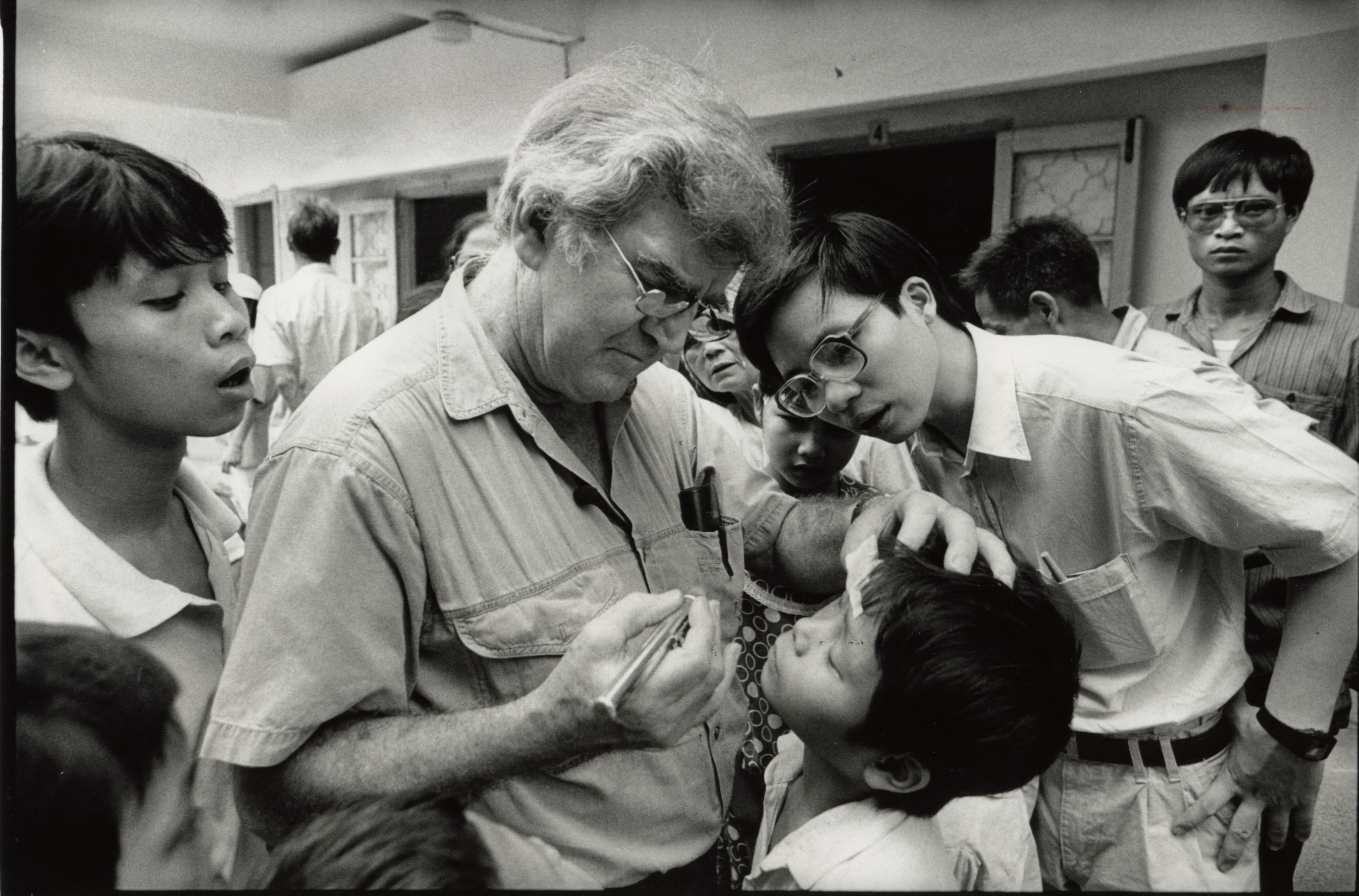 Professor Fred Hollows examining a boys eyes in Hanoi, Vietnam in 1992.