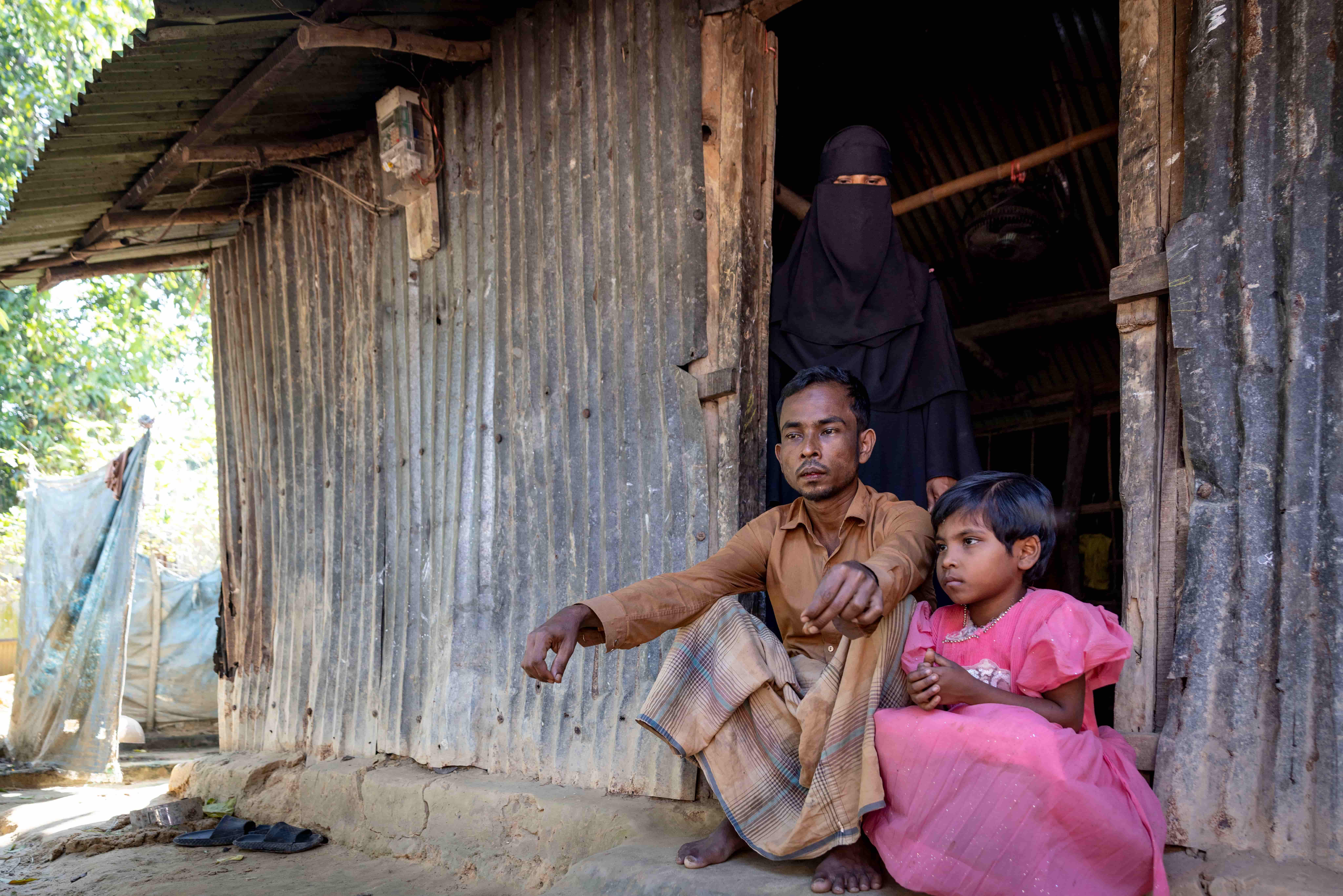 Obiadul sitting with his daughter outside their home