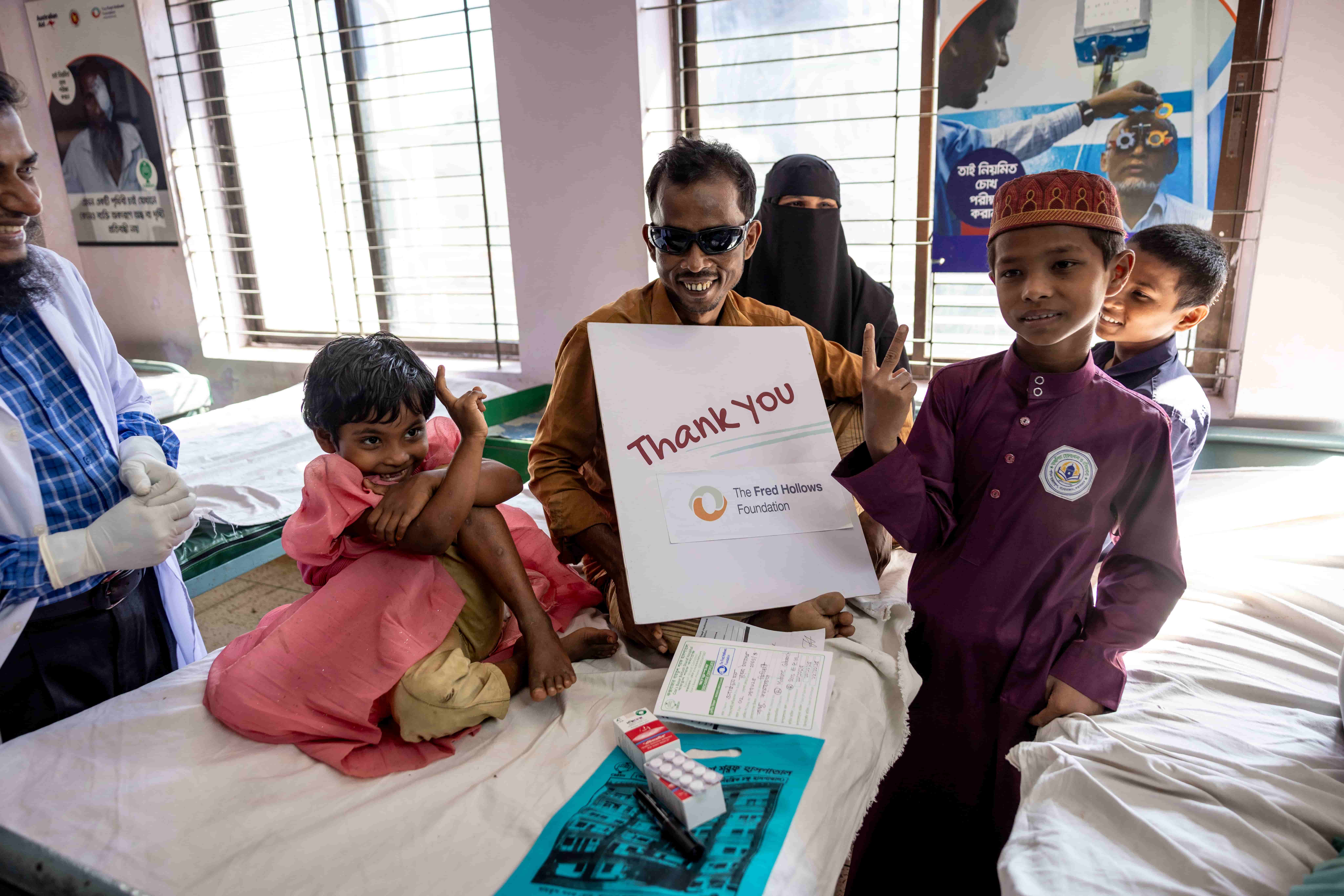 Obaidul holds a handmade thank you sign for supporters of The Fred Hollows Foundation and the Australian NGO Cooperation Program whose generosity helped restore his sight and hope.