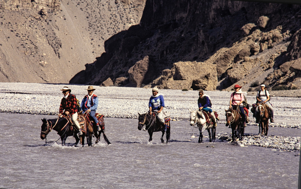 Dr Sanduk Ruit riding horseback with his team through Nepal's Kali Gandaki Gorge to bring sight-saving eye care to the remote Upper Mustang region.