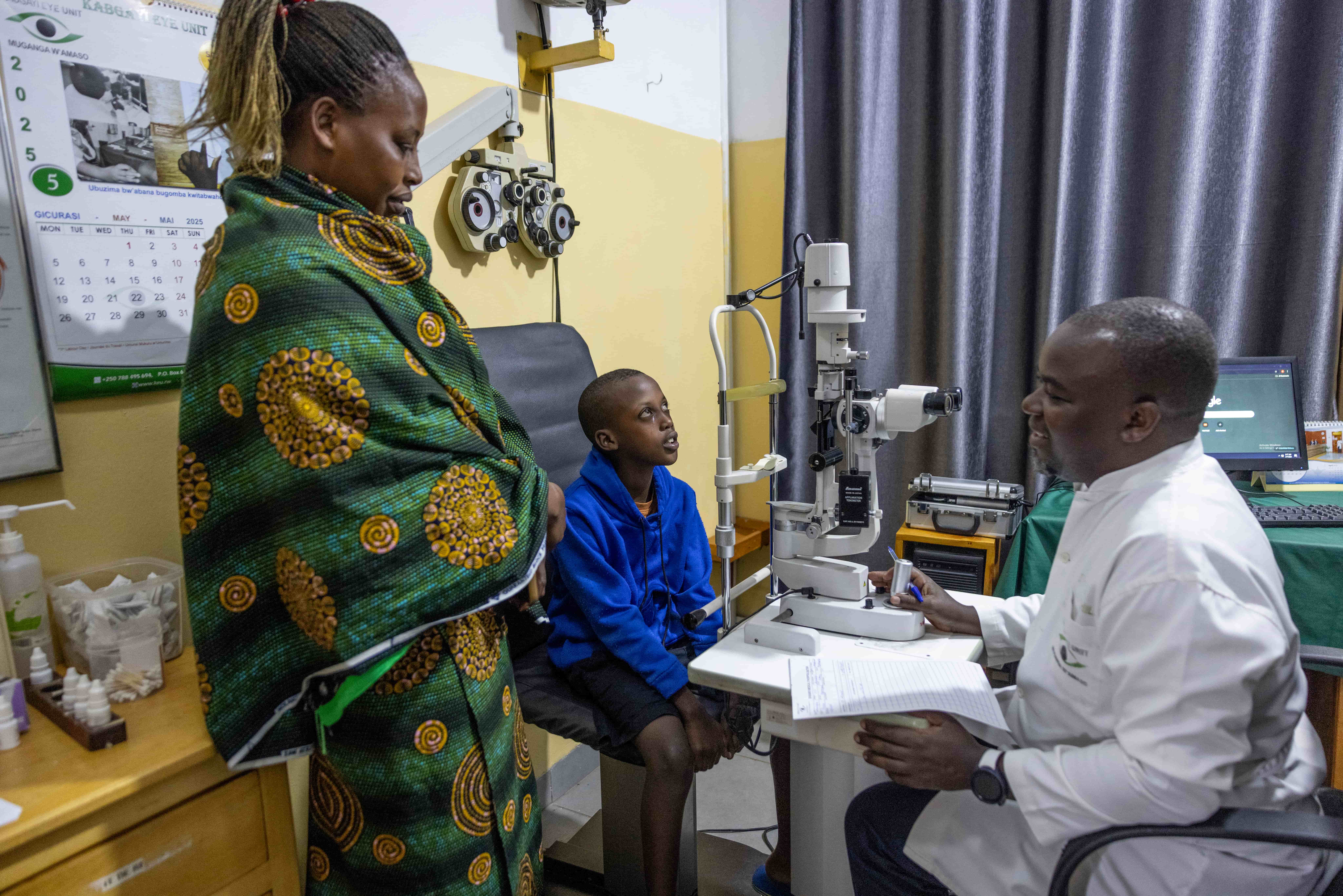 Dr Tuyisabe Theophile assesses Bright before surgery, ensuring the 12-year-old receives personalised care to restore his sight and support his dreams for the future.
