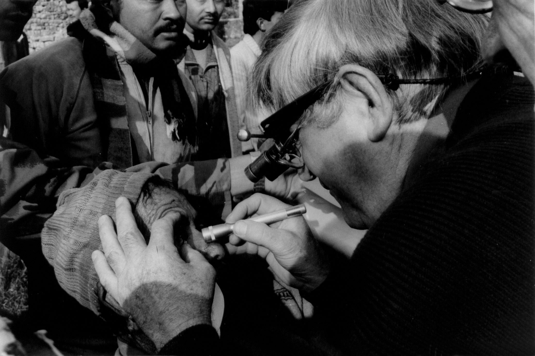 Fred Hollows examines a Nepalese patient following IOL surgery at the NEPA Eye Camp in Tupche, a small village in Nepal.