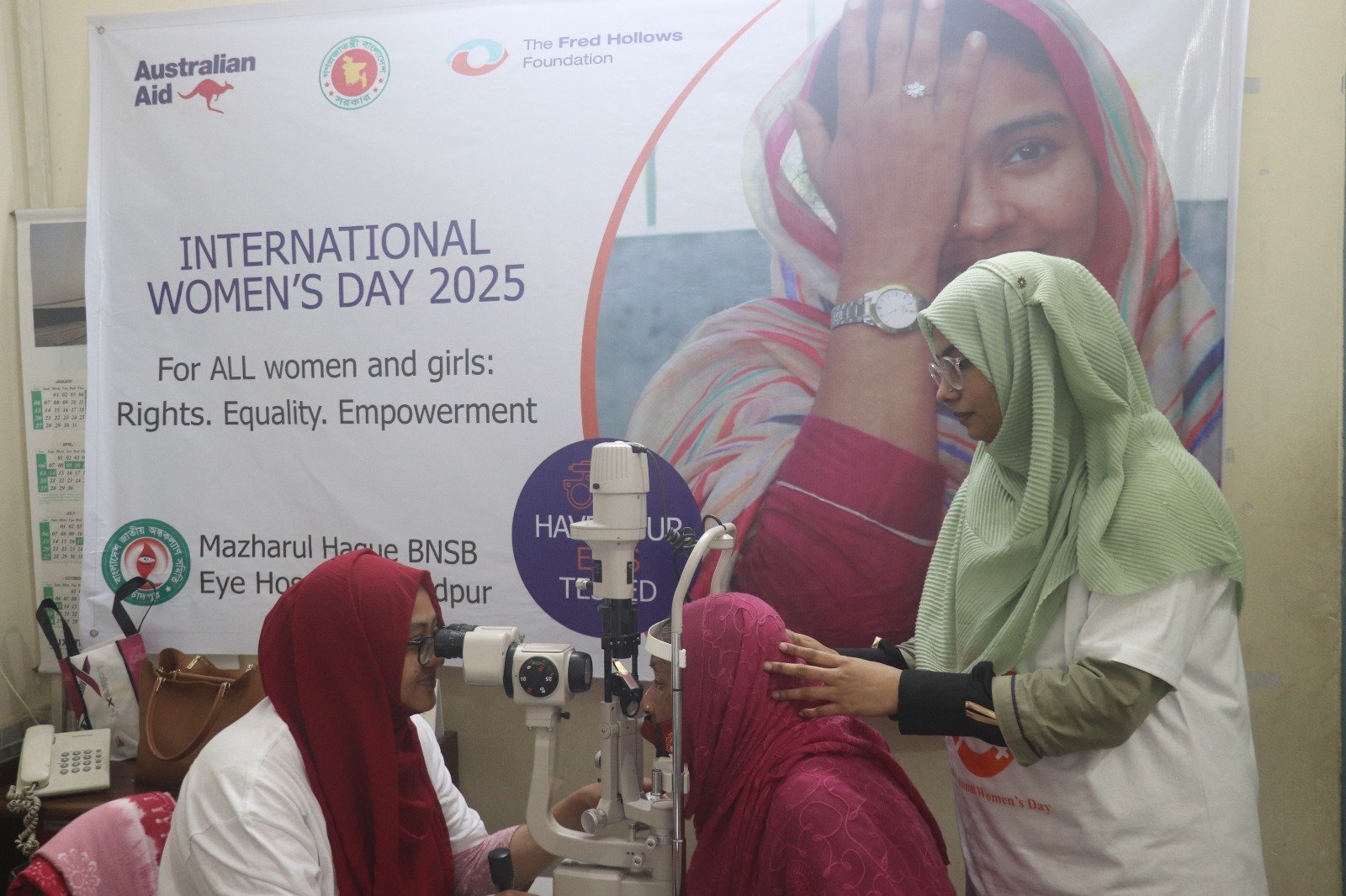 A woman in Bangladesh has her eyes examined with a diagnostic machine during an International Women’s Day outreach camp.