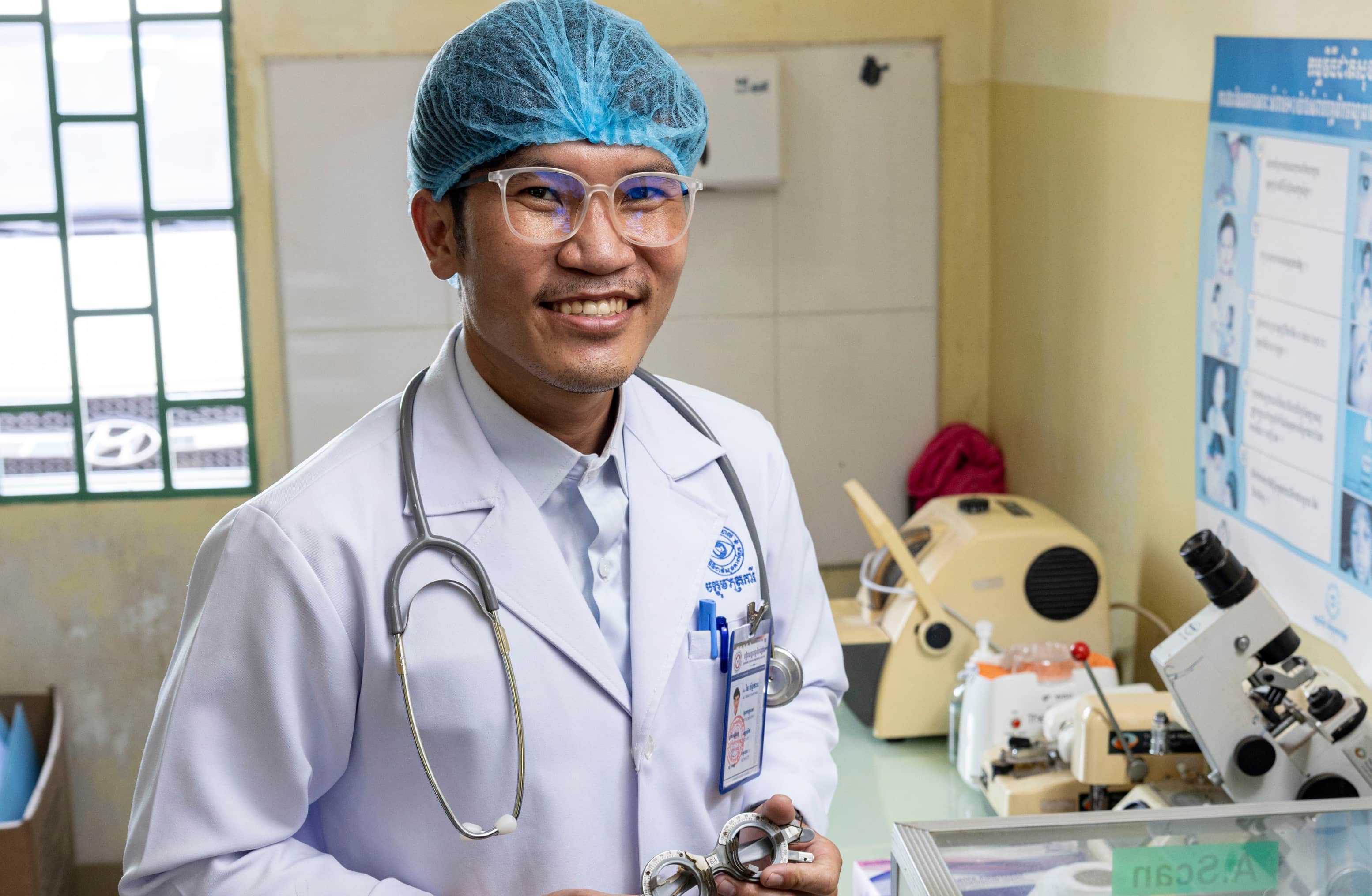 Chhai Channdara, an optometrist in Kampong Chhnang, Cambodia, stands in the screening area where he checks patients’ vision and prescribes corrective lenses.