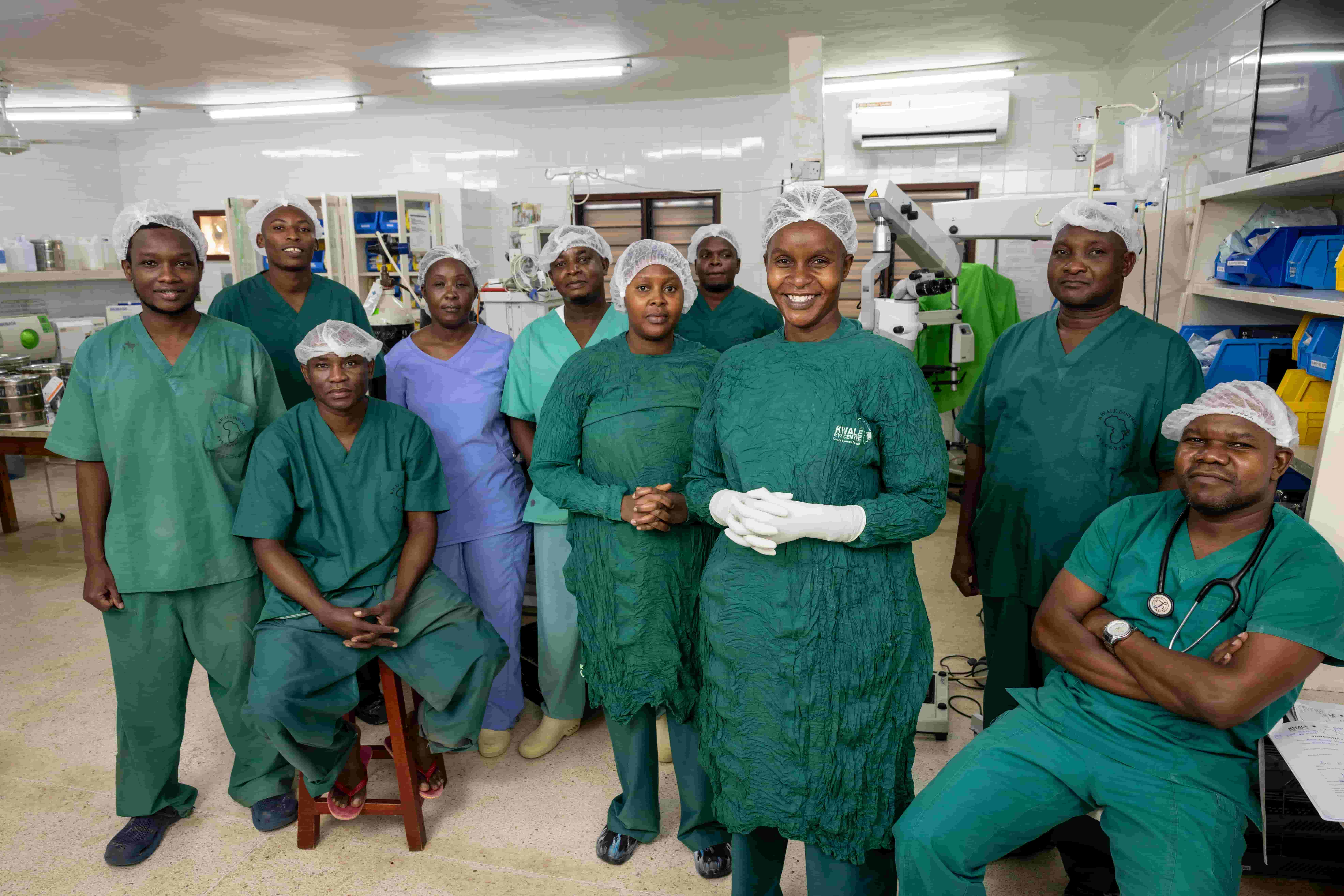 A group of eye care professionals pose together at Kwale Eye Centre in Kenya, celebrating their work in paediatric surgery and ongoing vision care for children.