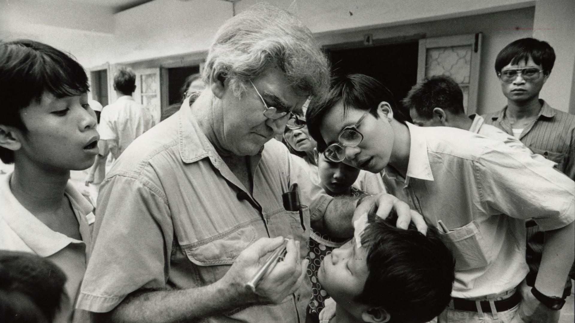 Fred Hollows examining a child's eyes in Hanoi, Vietnam