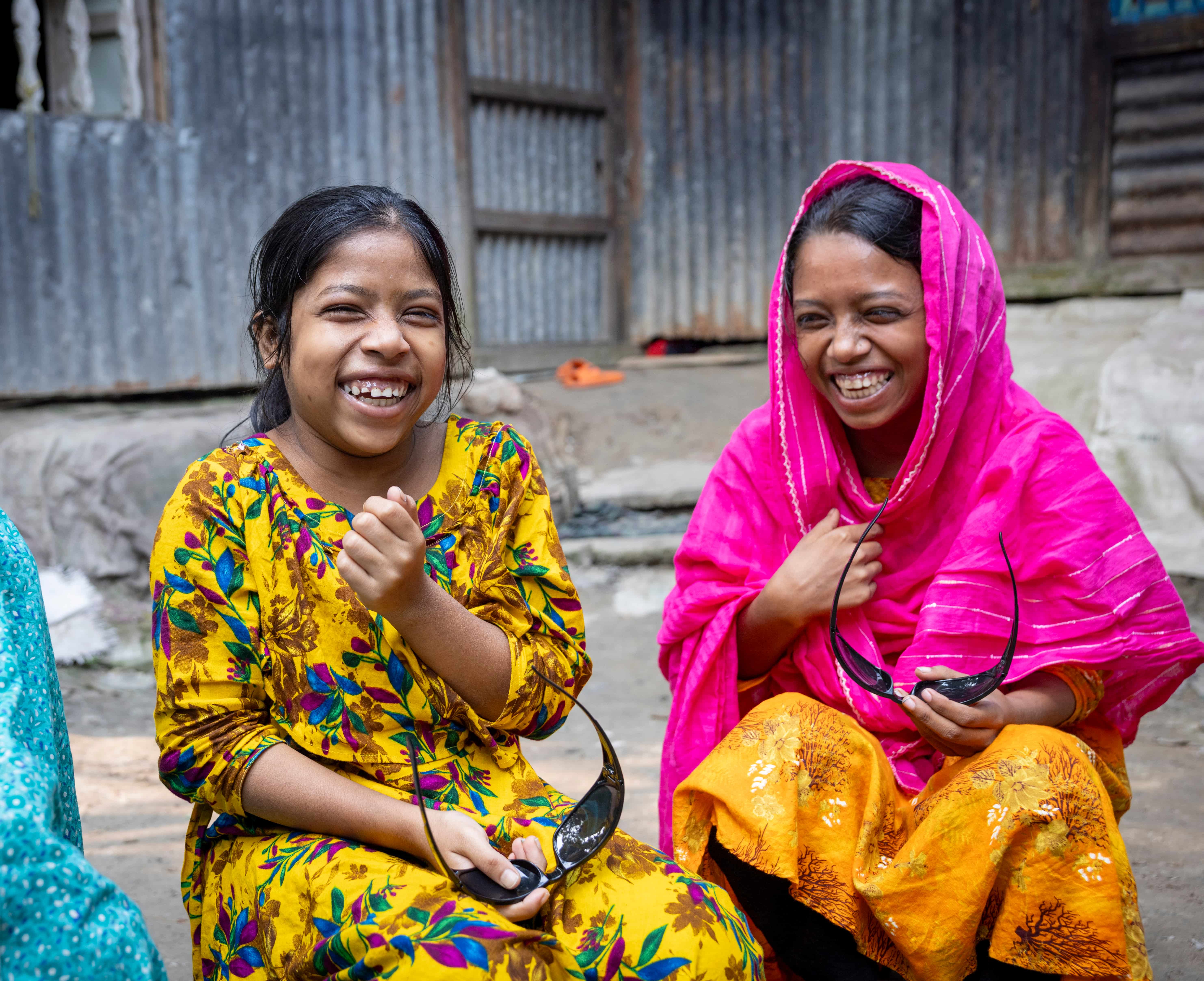 Sumaiya and Habiba smile after having their sight restored through cataract surgery in Chandpur, Bangladesh. Their parents are hopeful the sisters can return to school, play with their friends and look forward to a brighter future.