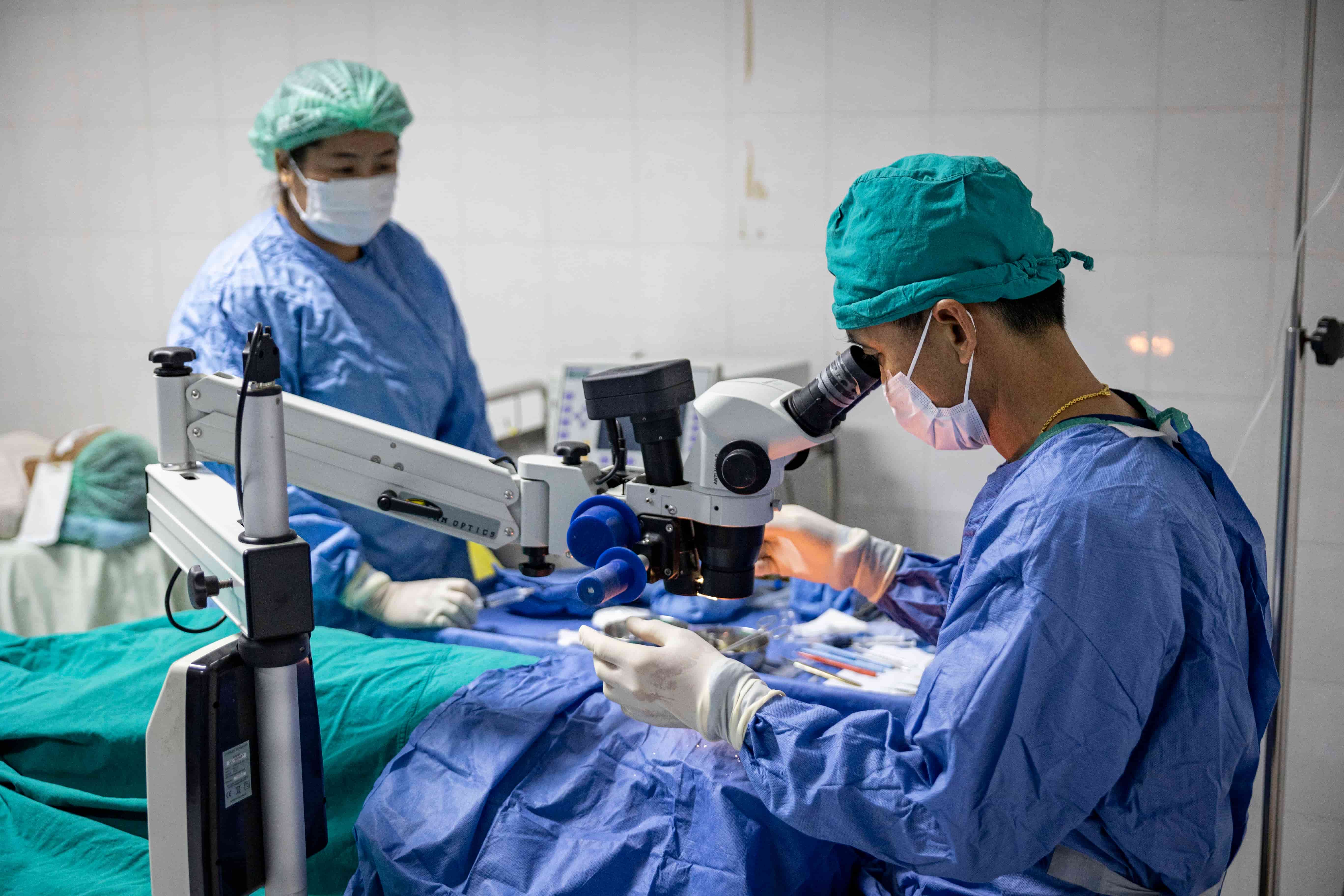 Dr Senglar Laorsen and Dr Phetsamone Indara complete cataract surgery at Oudomxay Provincial Eye Hospital in Lao PDR, where The Fred Hollows Foundation is helping expand access to affordable eye care for people at risk of avoidable blindness.