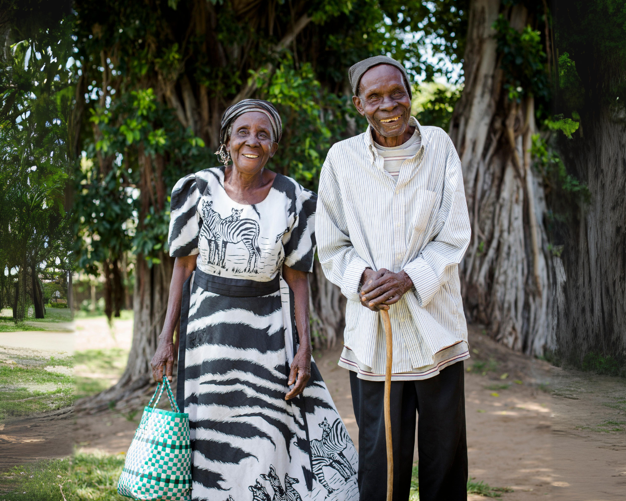 Kenyan couple standing side by side and smiling at the camera